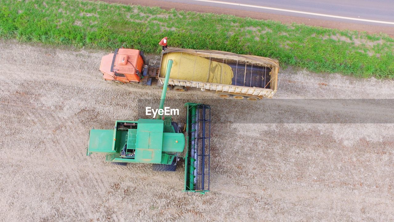 High angle view of tractors on ploughed field