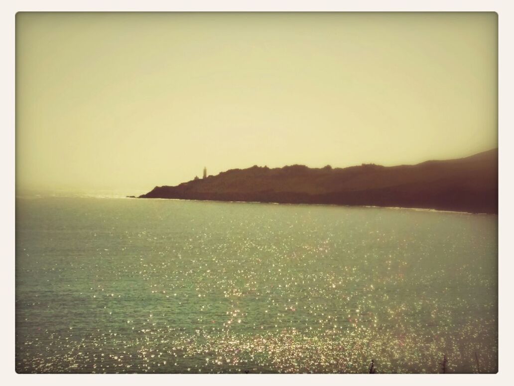 SCENIC VIEW OF SEA WITH TREES IN BACKGROUND