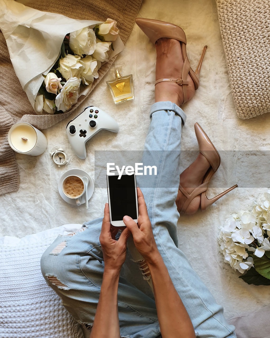 High angle view of woman holding phone relaxing at home