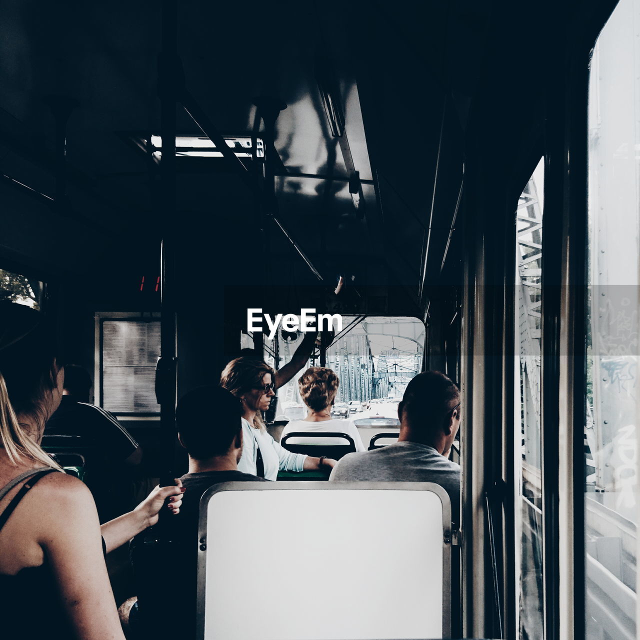 REAR VIEW OF WOMAN SITTING IN TRAIN