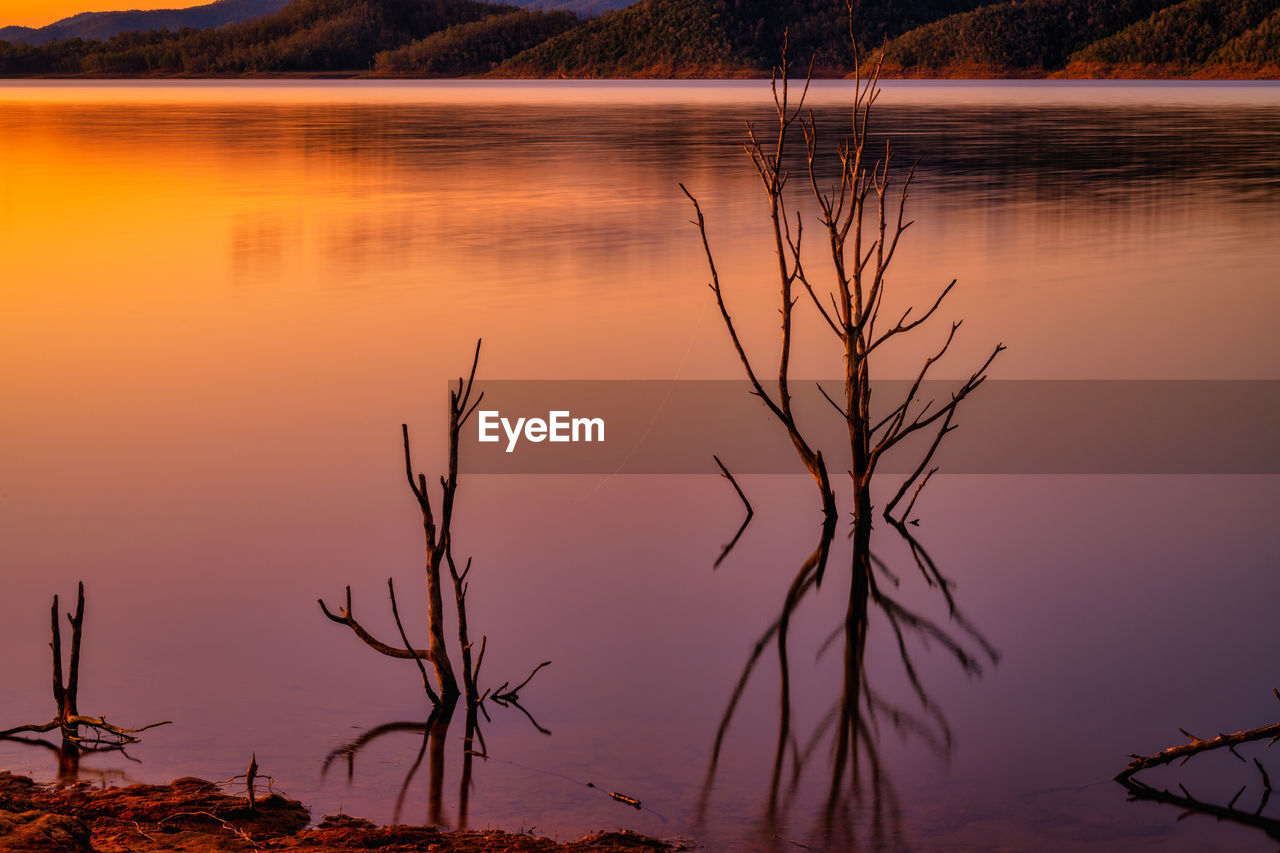 SCENIC VIEW OF LAKE AGAINST ORANGE SKY