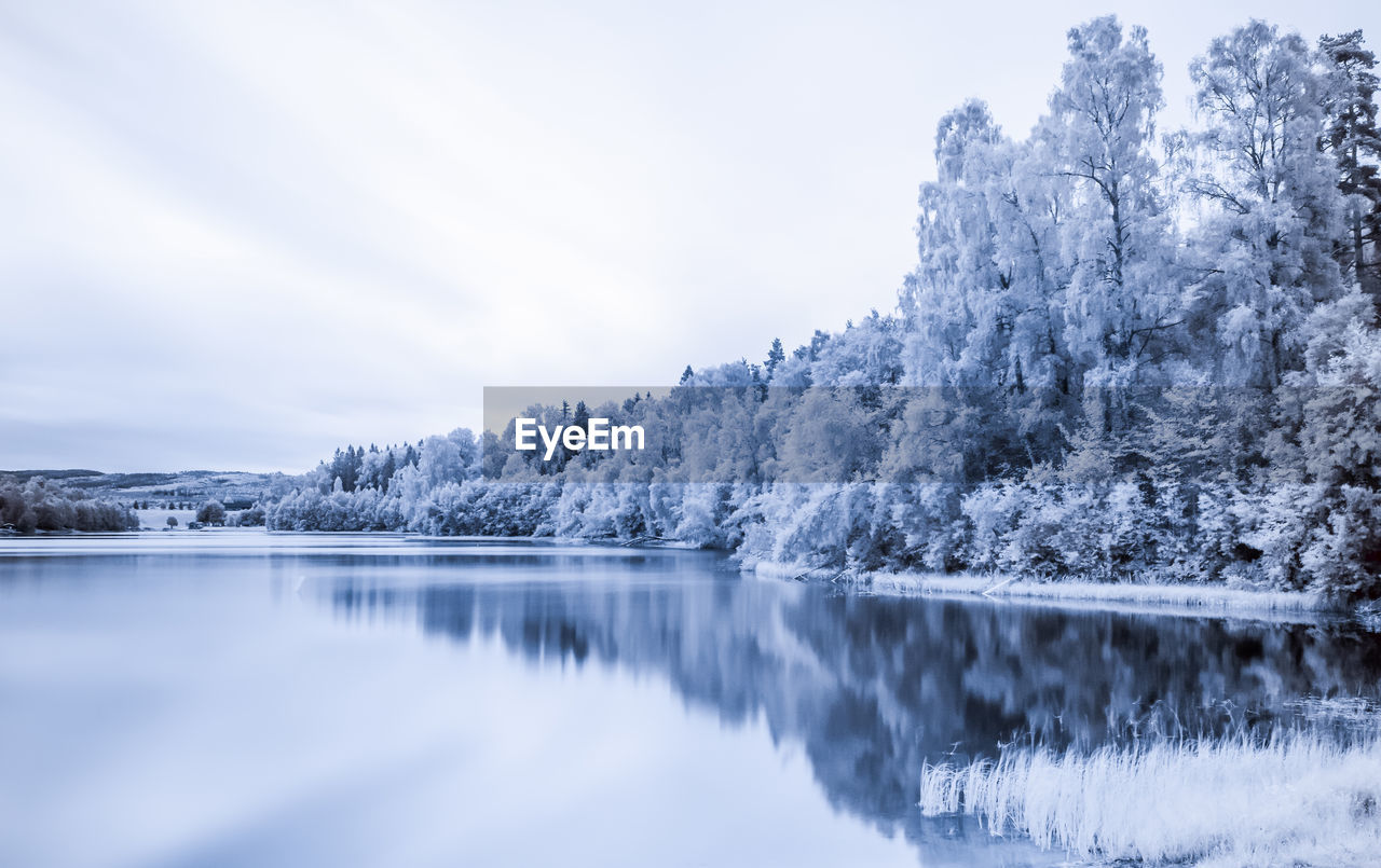 Scenic infrared view of lake against sky