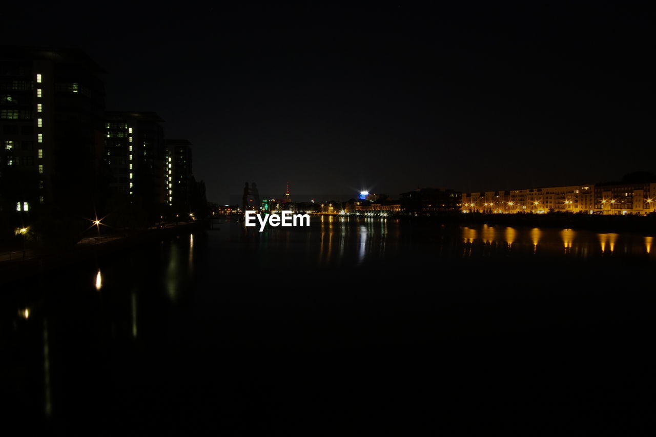 VIEW OF ILLUMINATED CITYSCAPE AT NIGHT