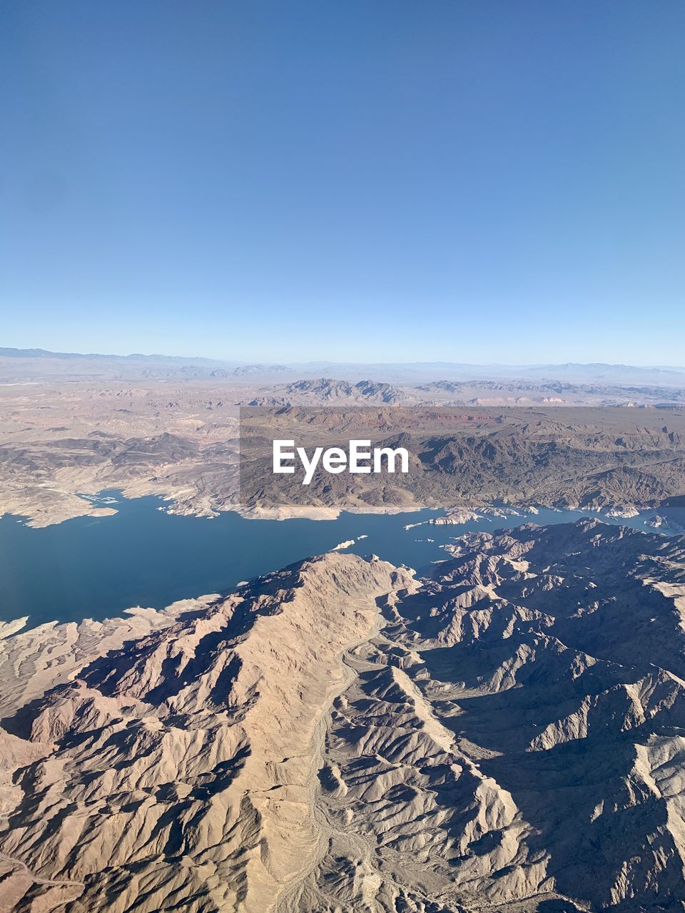 Scenic view of dramatic landscape against clear blue sky