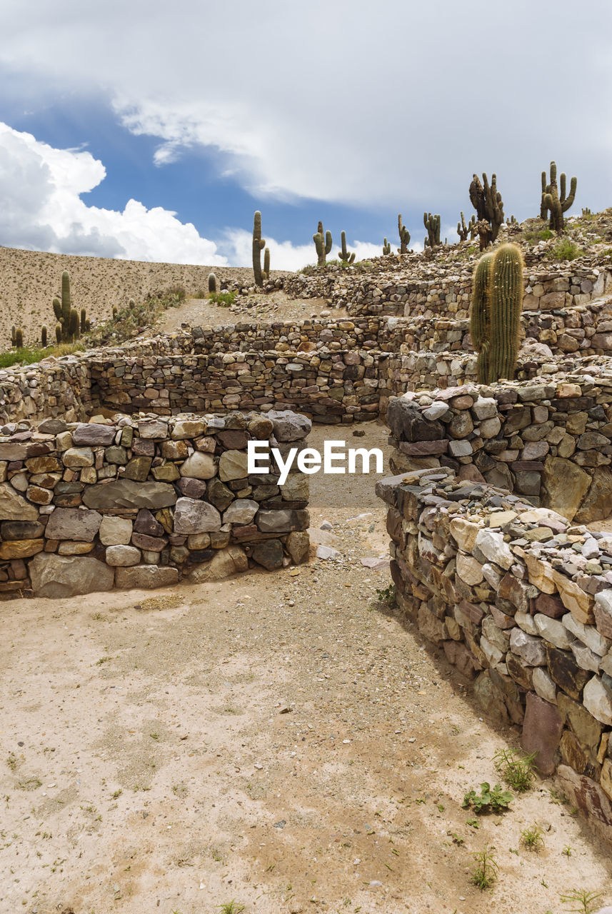 Stone walls against cloudy sky