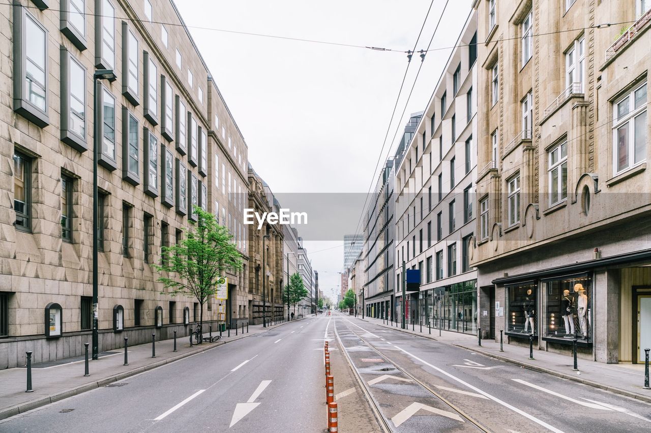 Empty road along built structures