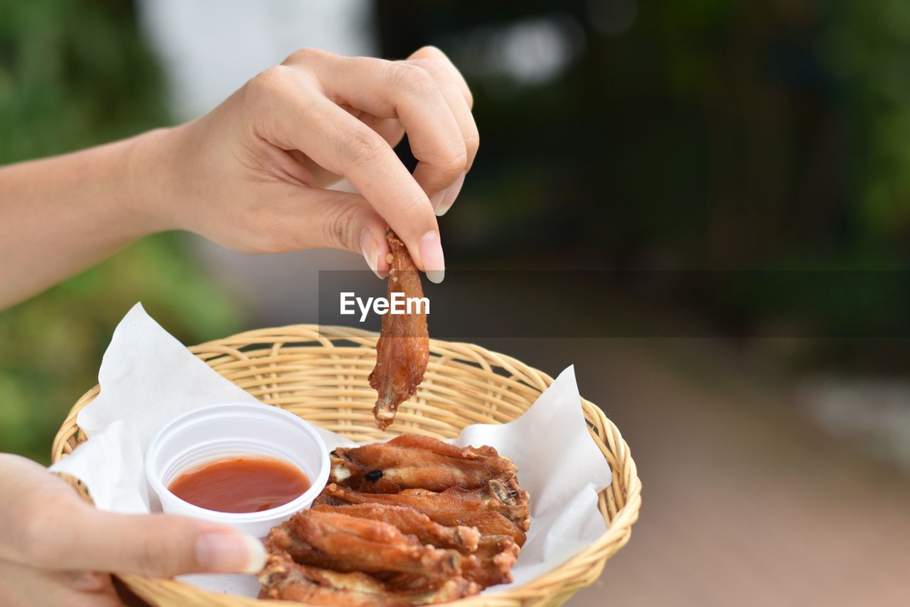 MIDSECTION OF PERSON HOLDING FOOD IN BOWL