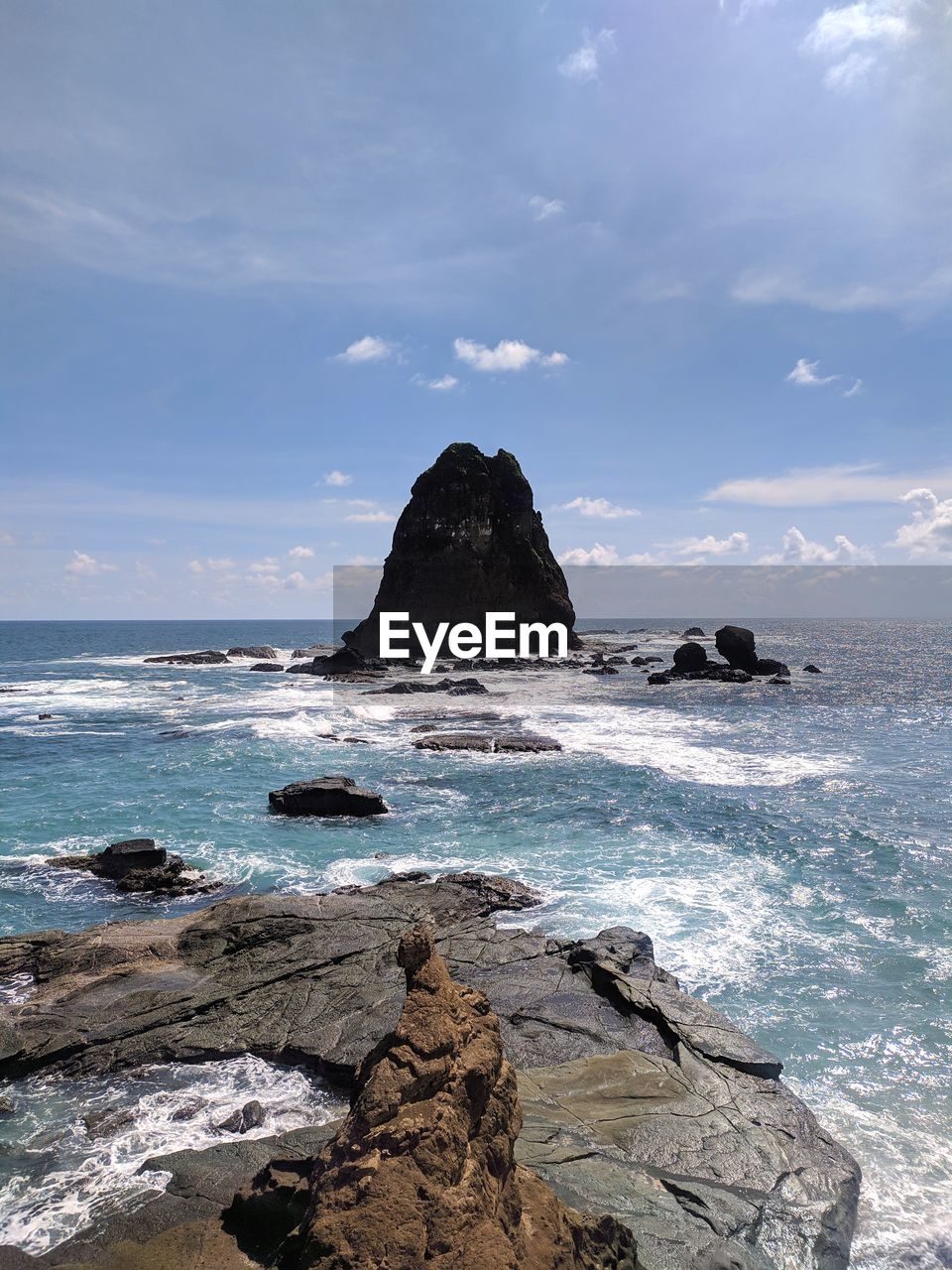 SCENIC VIEW OF ROCKS ON SHORE AGAINST SKY