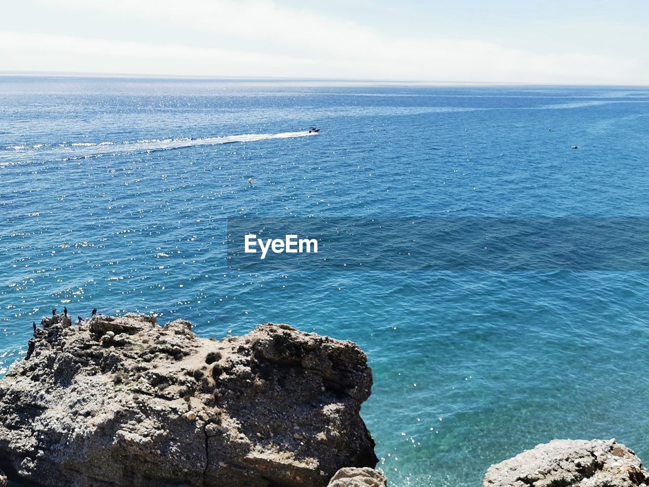 water, sea, beauty in nature, scenics - nature, ocean, rock, sky, shore, tranquility, tranquil scene, horizon, nature, land, horizon over water, beach, coast, day, no people, body of water, idyllic, blue, cliff, outdoors, non-urban scene, terrain, high angle view, rock formation, islet, wave, bay, cloud, sunlight, travel