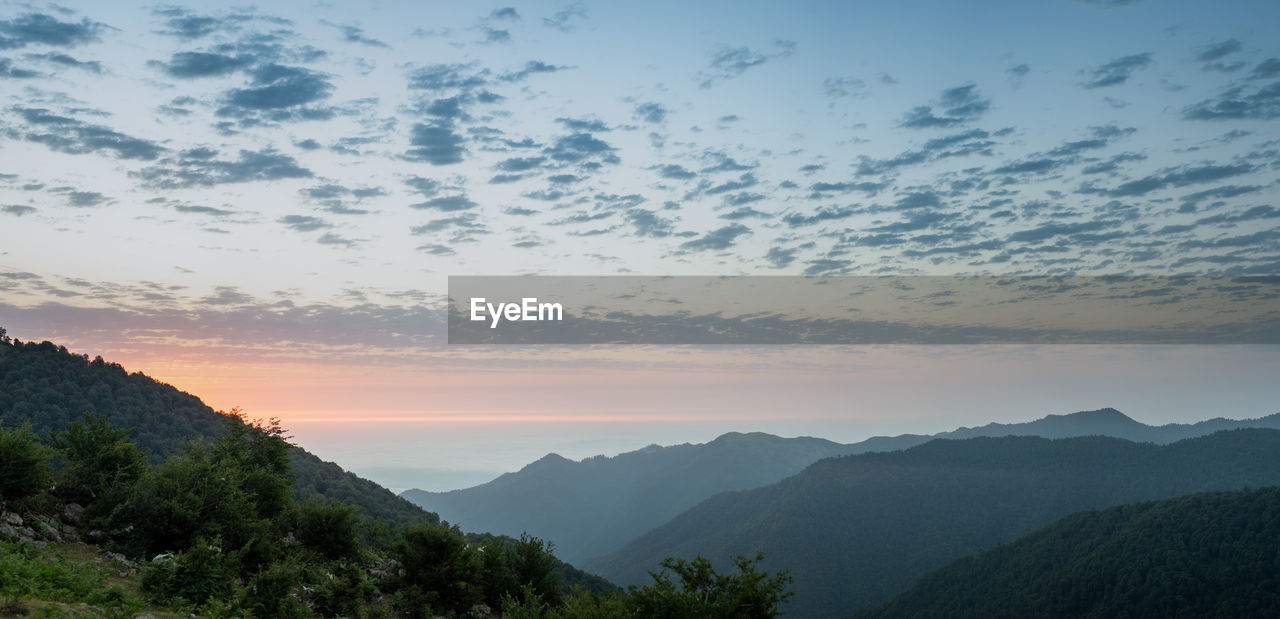 SCENIC VIEW OF SILHOUETTE MOUNTAINS AGAINST SKY DURING SUNSET