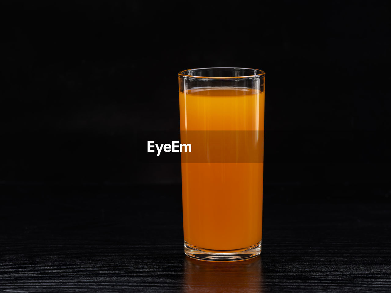 Close-up of orange juice in glass on table