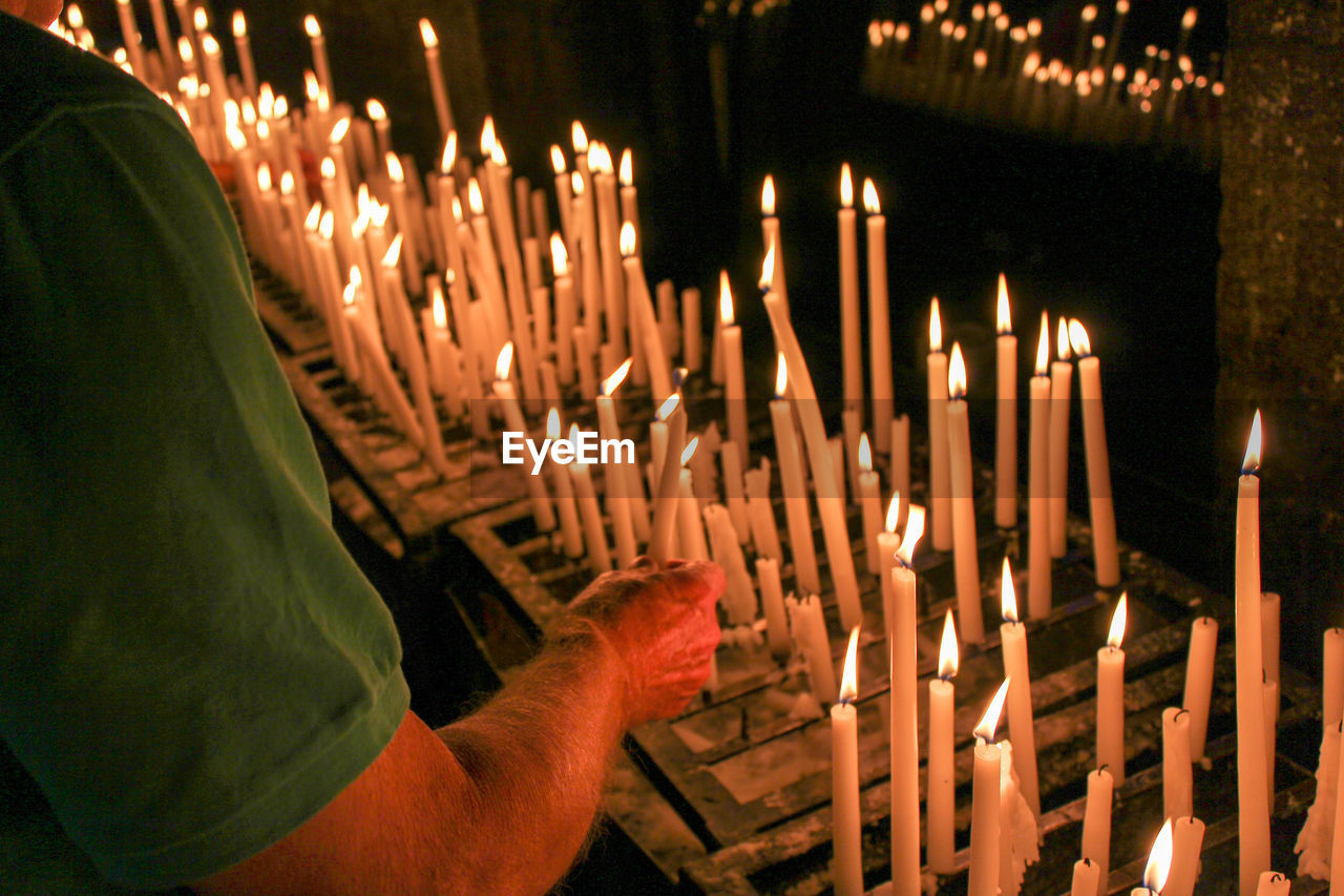 Panoramic view of lighting candles in a chapel