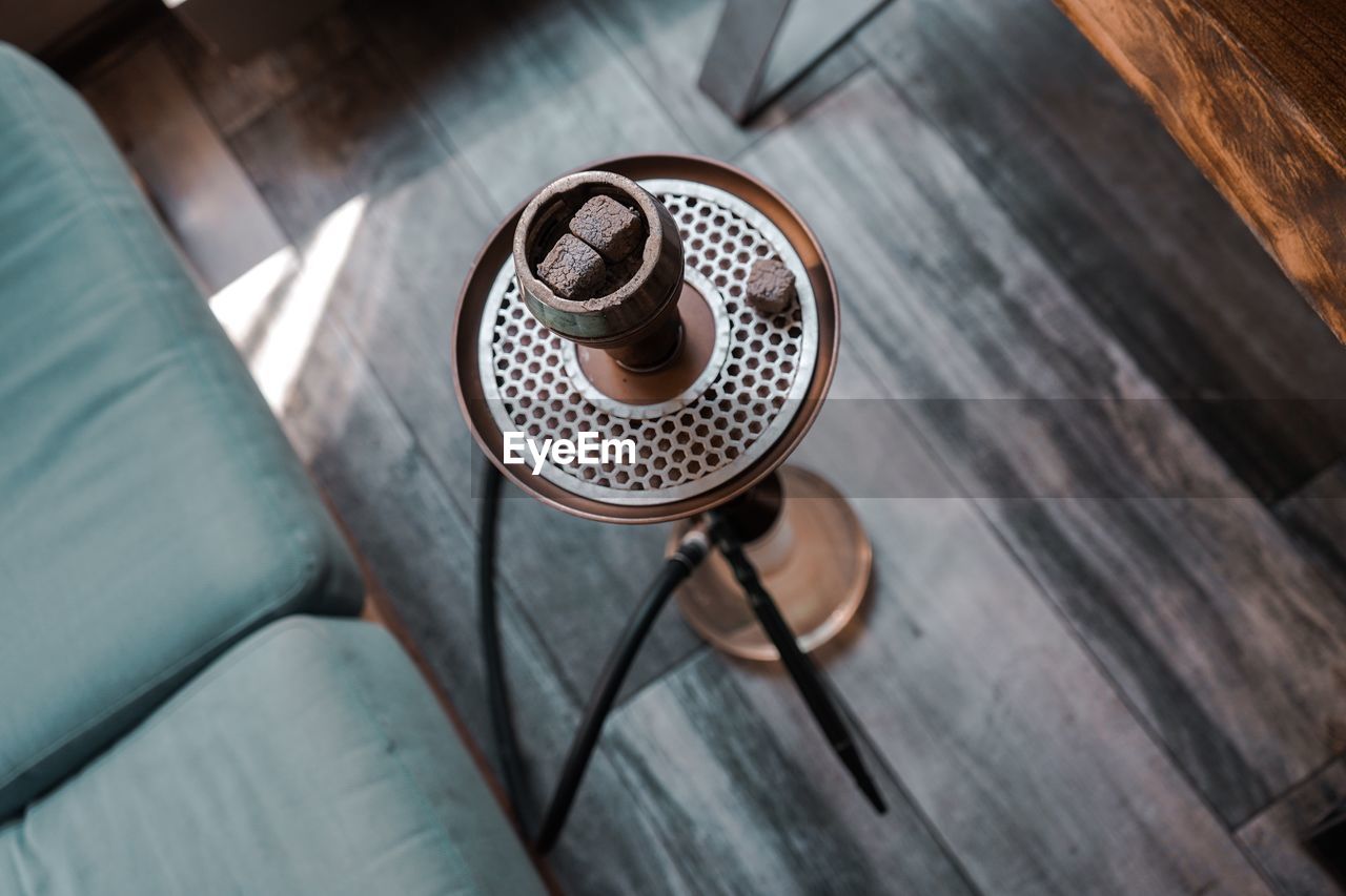 High angle view of hookah on hardwood floor at home