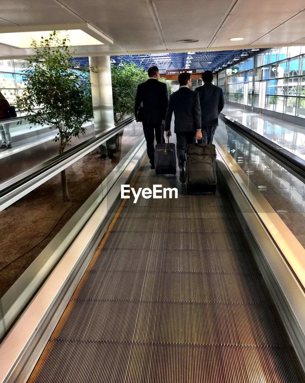 LOW ANGLE VIEW OF PEOPLE ON ESCALATOR