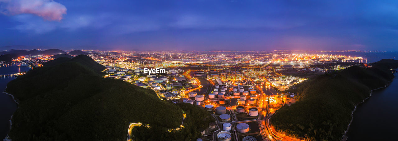 High angle view of illuminated buildings against sky at night