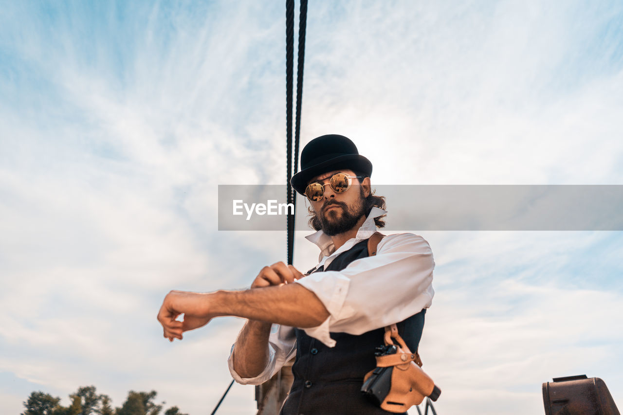 Low angle view of man standing against sky