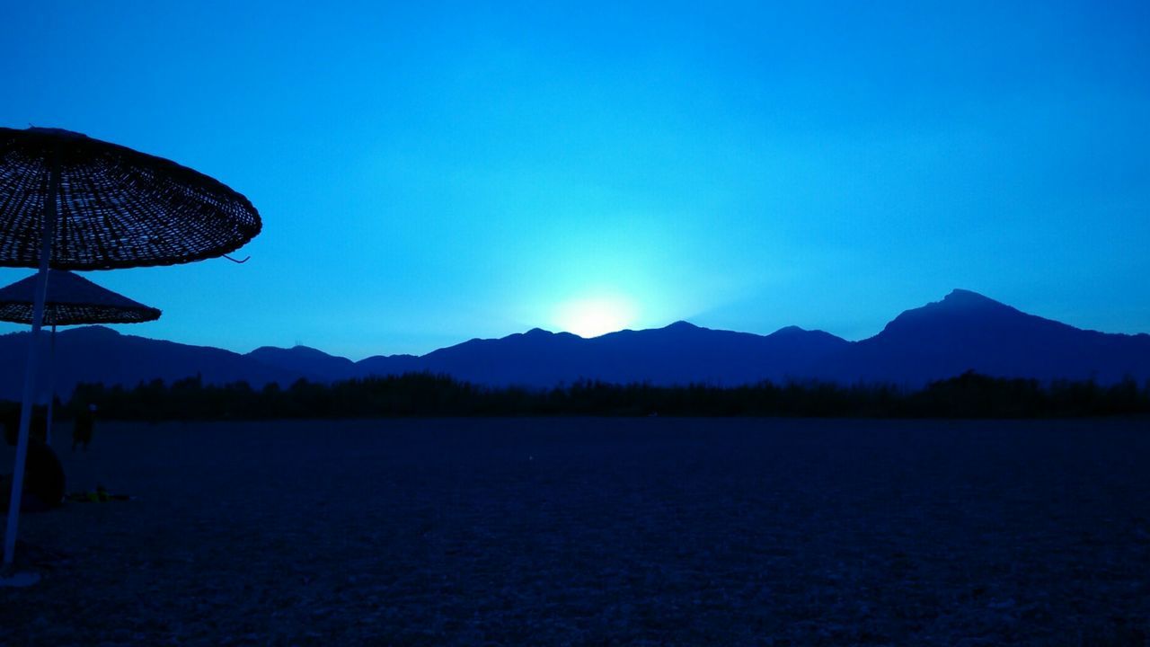 Scenic view of mountains against clear blue sky