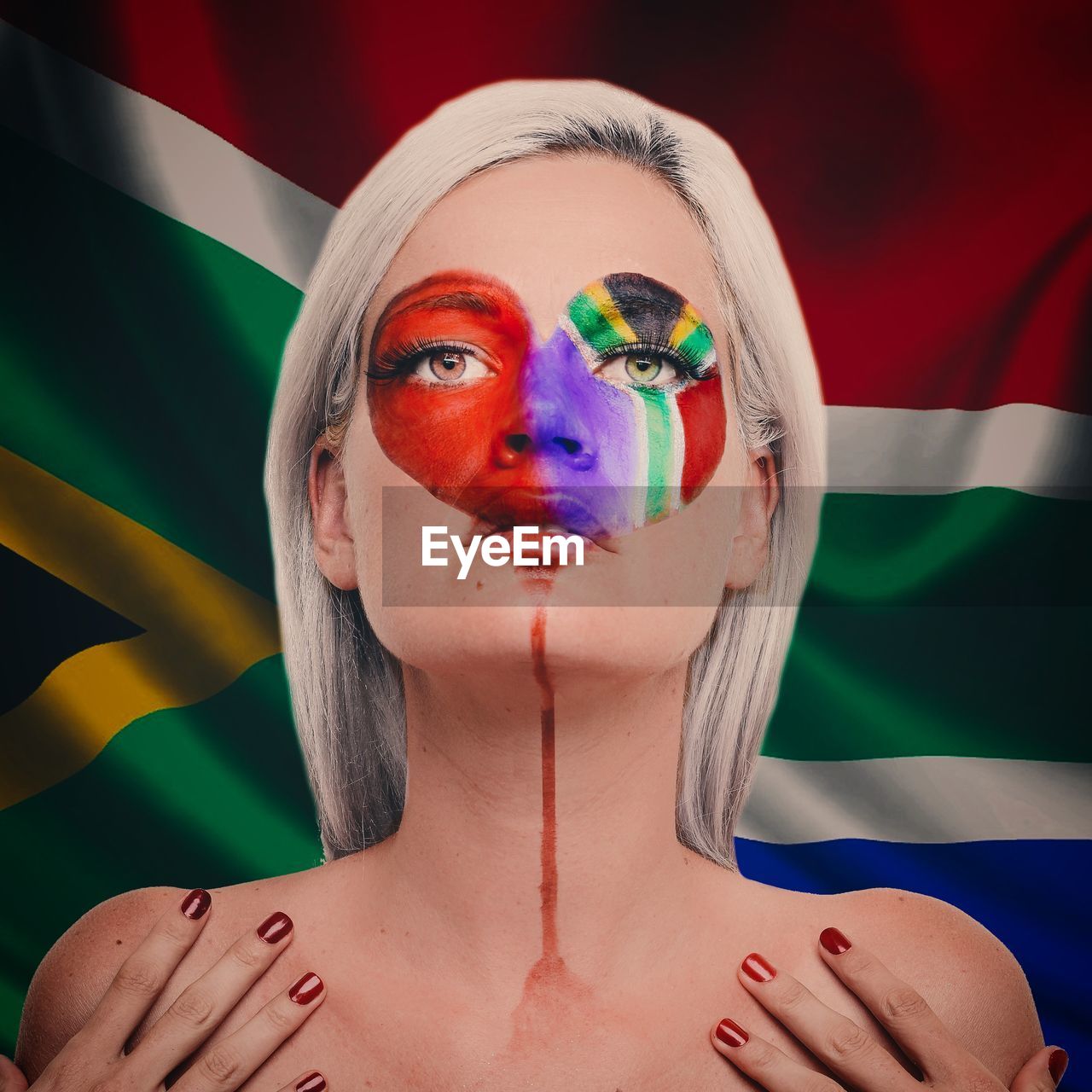 Close-up of young woman with south african flag face paint