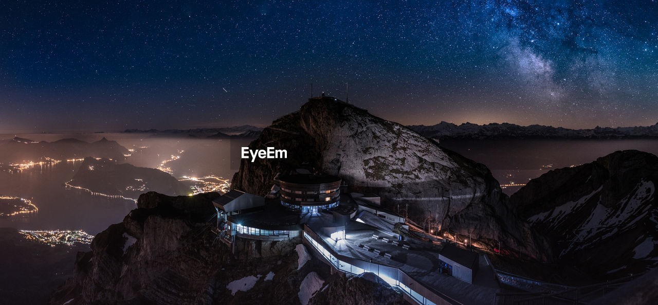 Panoramic view of snowcapped mountains against sky at night