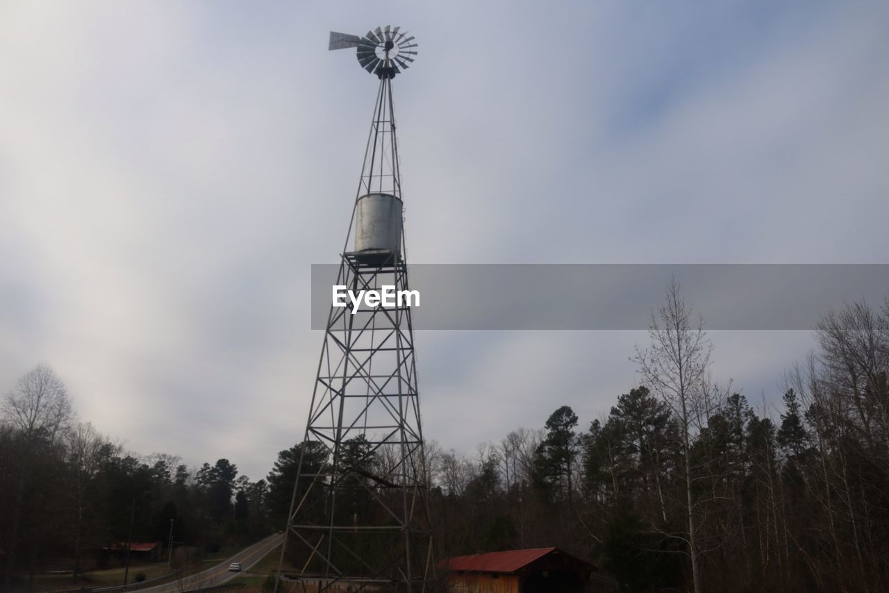 Low angle view of windmill against cloudy sky