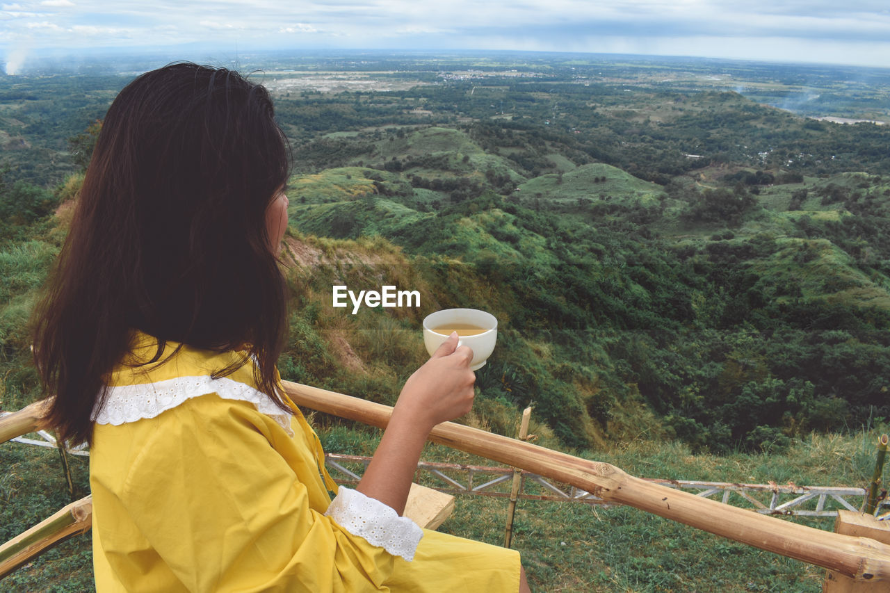 Rear view of woman looking at mountains