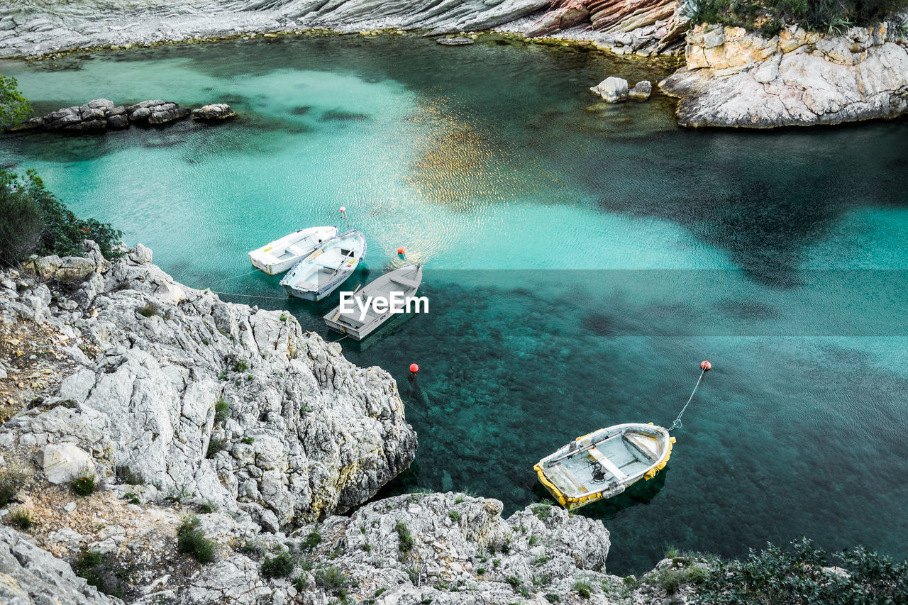 High angle view of boats moored by rock formations in river