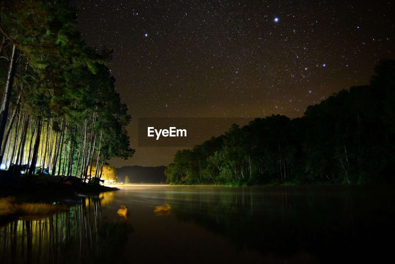 scenic view of lake against clear sky at night