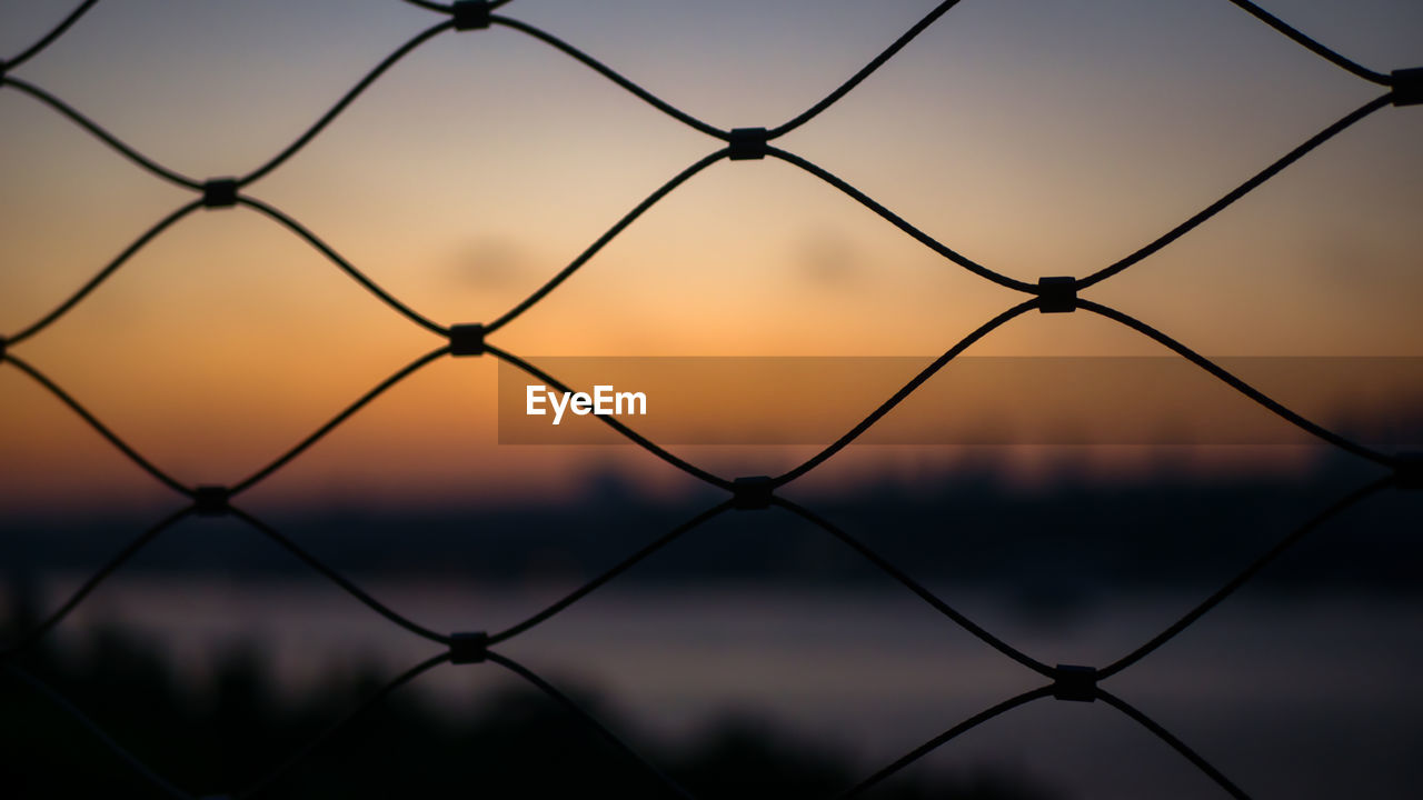 Beautiful istanbul sunset golden hour through fence cage selective focus