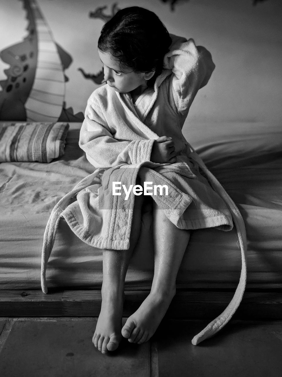 Cute girl wearing bathrobe at home