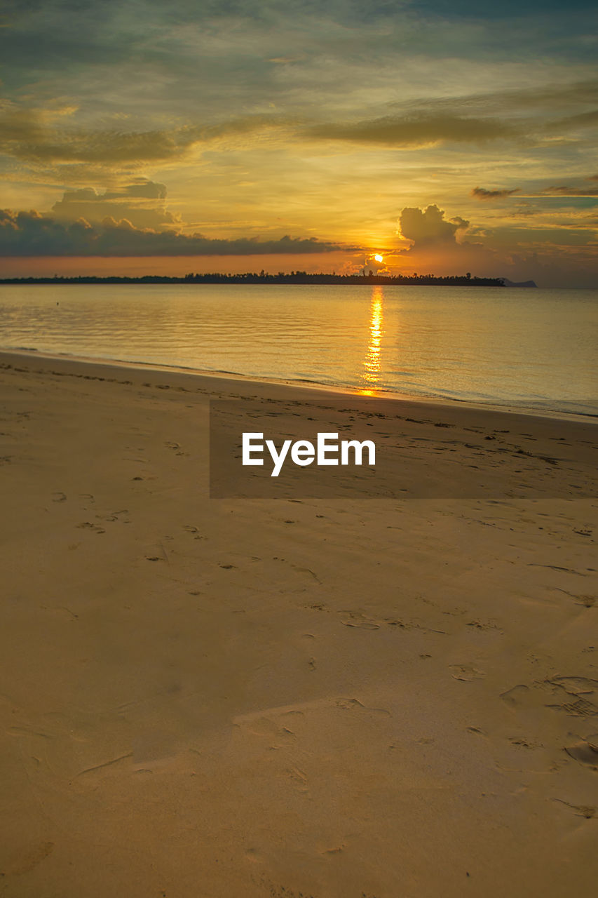 Scenic view of calm sea at sunset