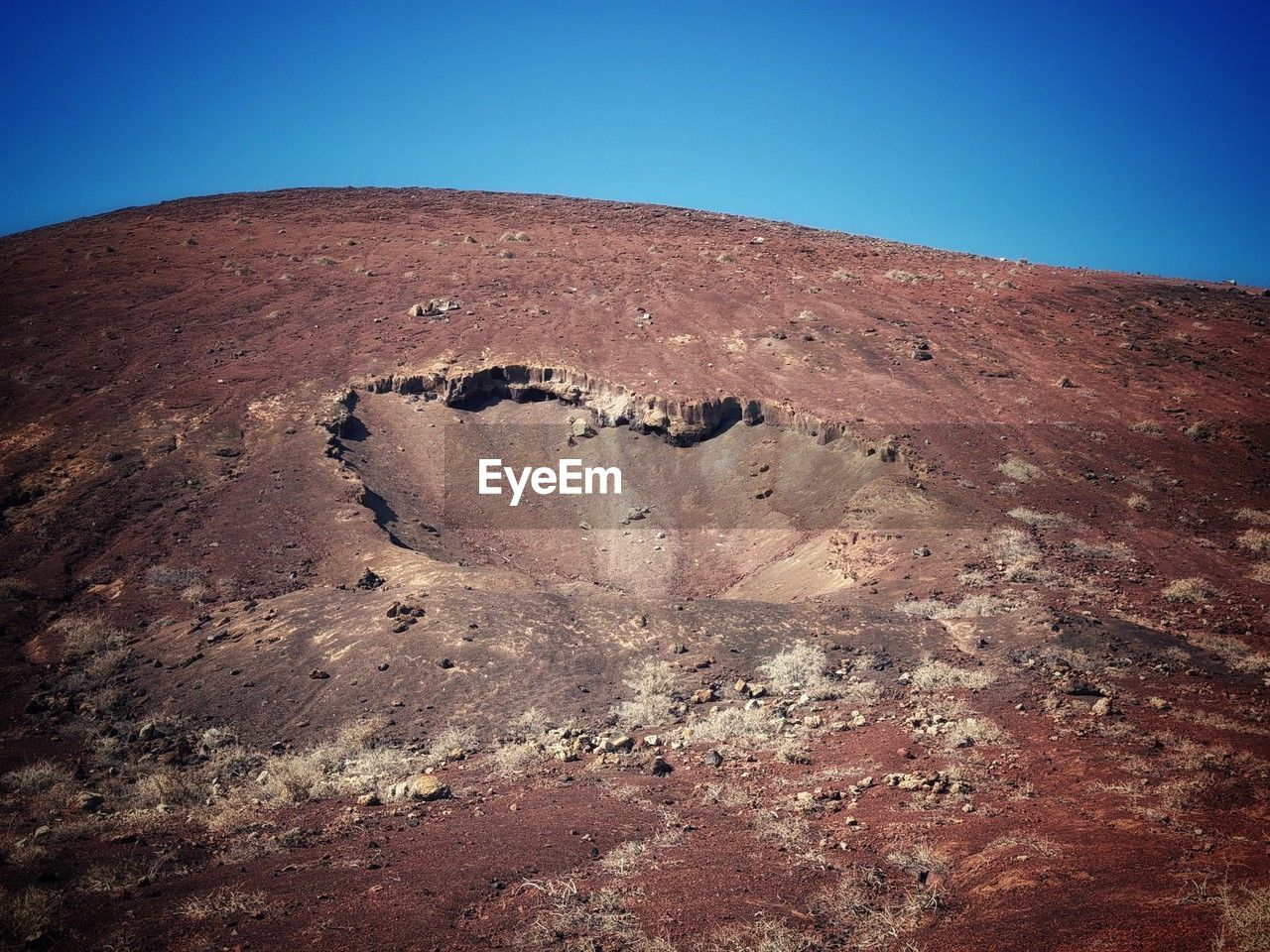 sky, nature, landscape, environment, rock, land, no people, scenics - nature, clear sky, mountain, desert, day, blue, beauty in nature, non-urban scene, soil, outdoors, tranquility, geology, tranquil scene, climate, travel destinations, extreme terrain, volcano