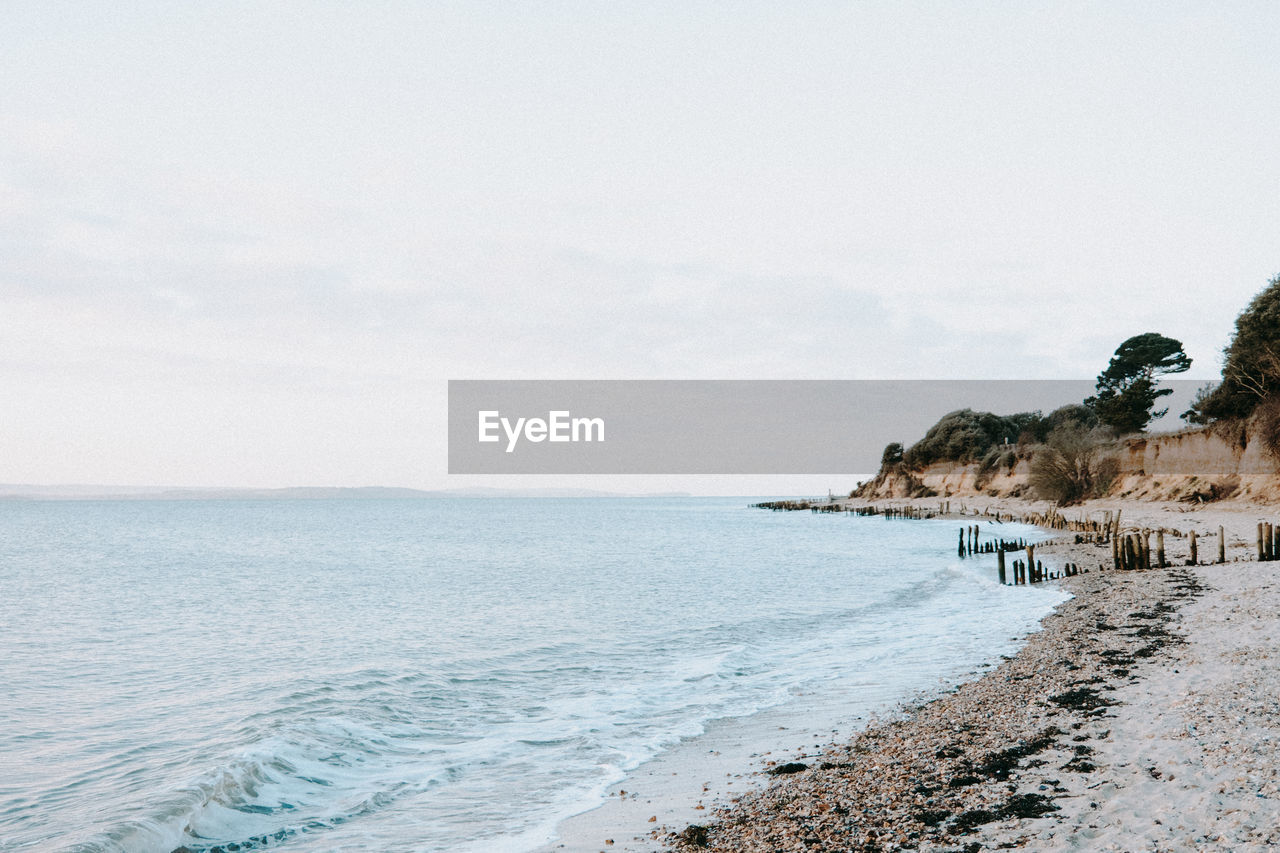 scenic view of beach against clear sky