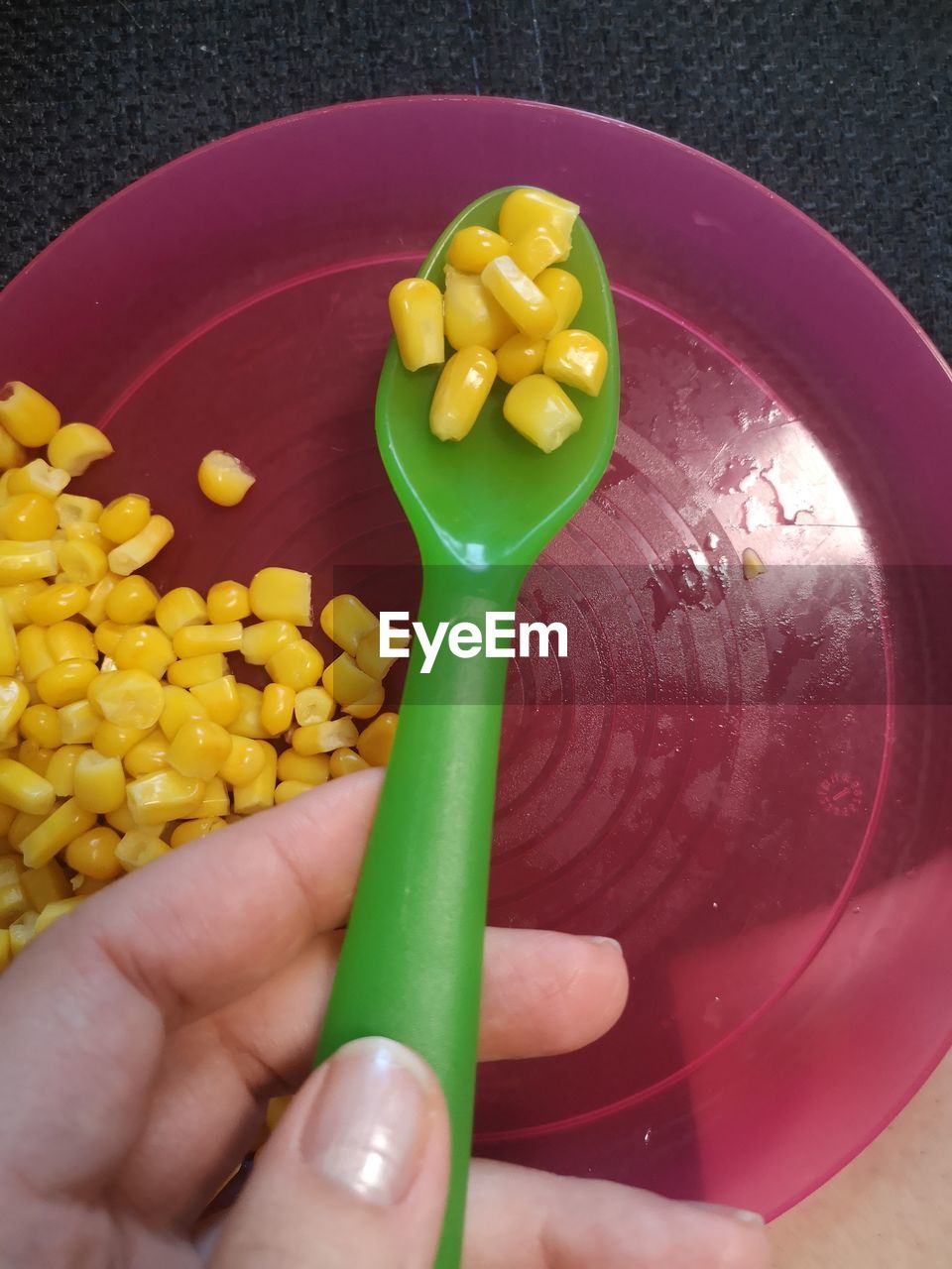 HIGH ANGLE VIEW OF PERSON HOLDING YELLOW AND VEGETABLES