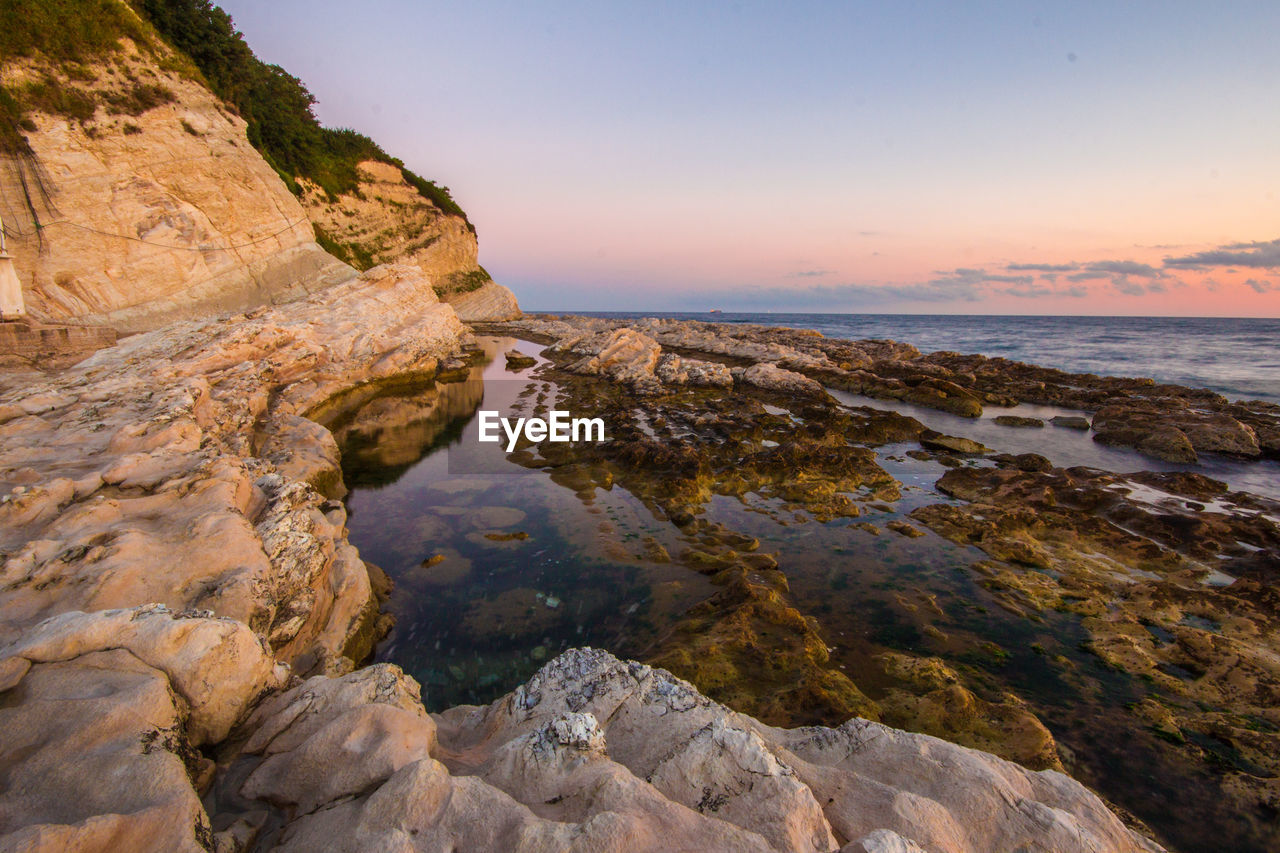 Scenic view of sea against sky at sunset