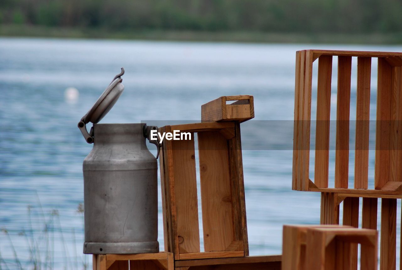 Canister on wooden crates at lakeshore