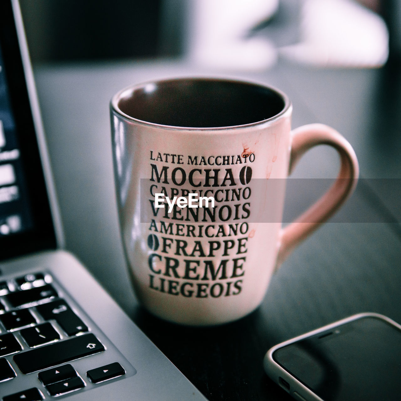 CLOSE-UP OF COFFEE CUP ON TABLE AT HOME