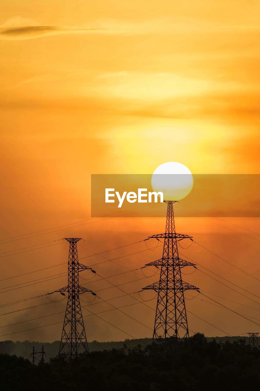 Electricity pylon against sky during sunset