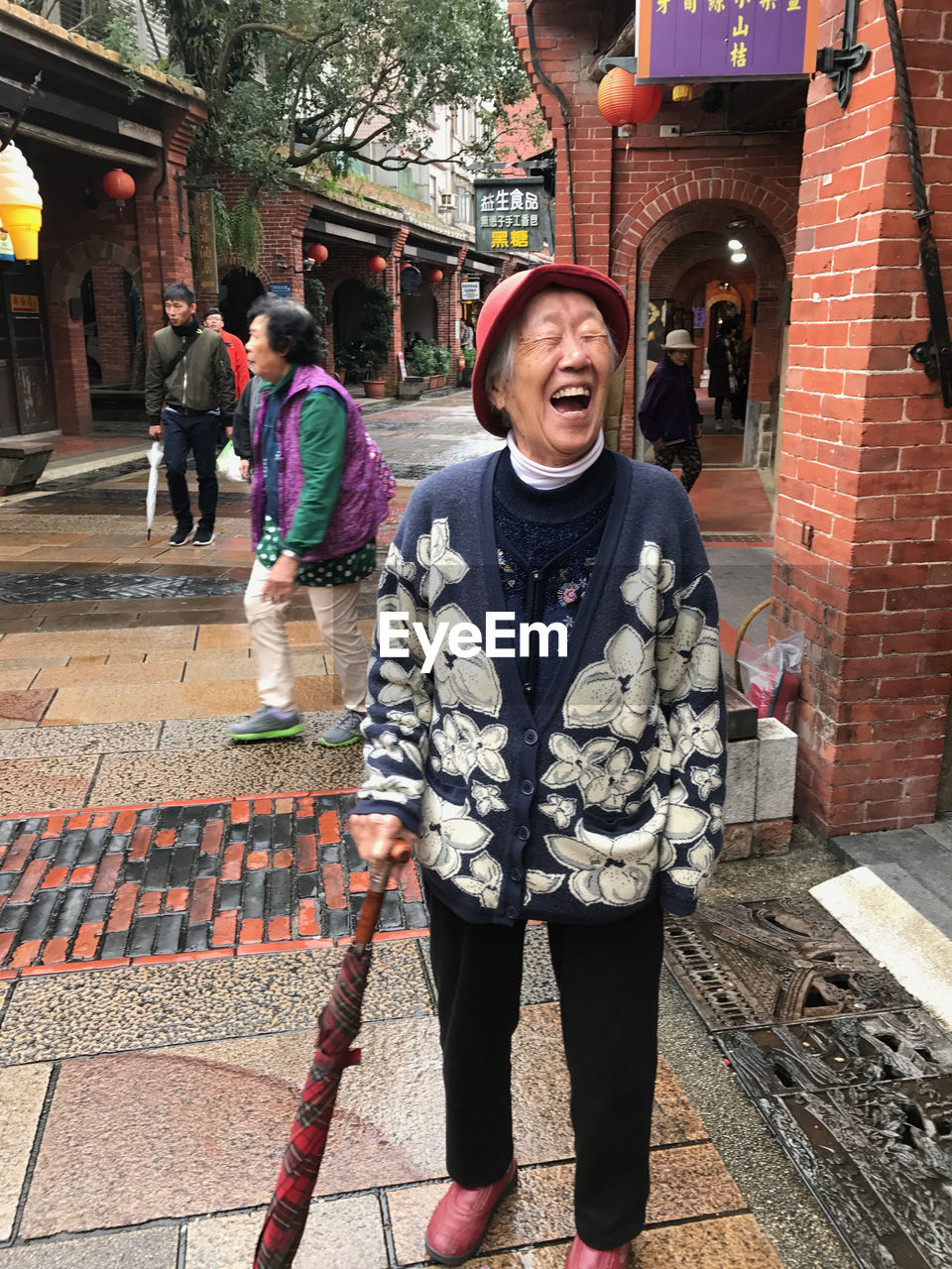 FULL LENGTH OF MAN STANDING ON GROUND IN A TOWN