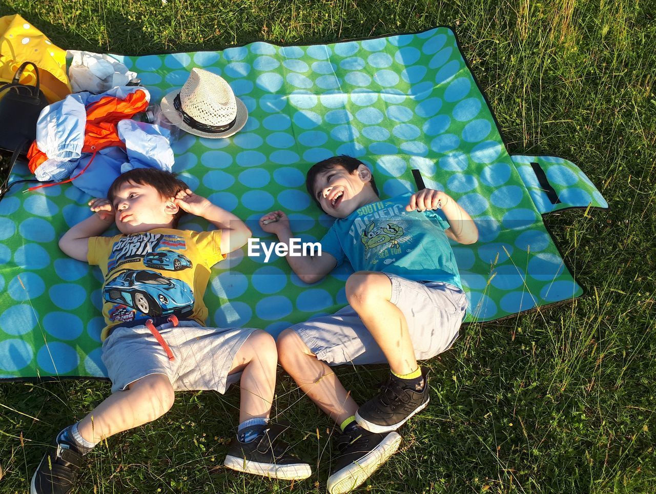 High angle view of friends lying on field