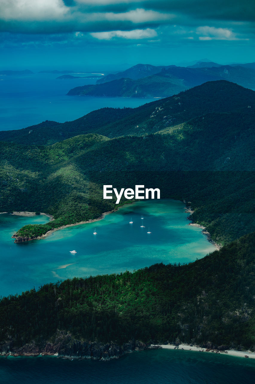 Scenic view of sea and mountains against sky - whitsunday islands, great barrier reef, australia