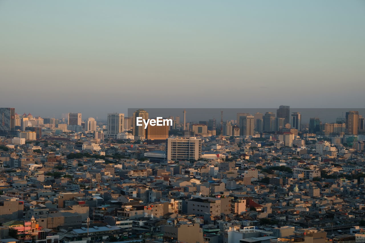 High angle view of buildings in city against clear sky