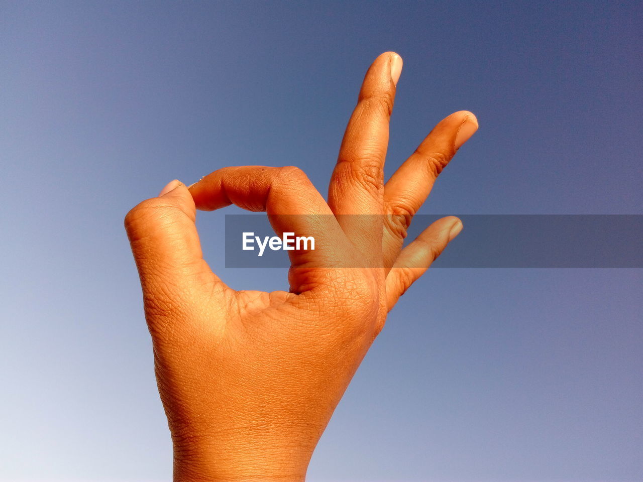 Human hand forming ok sign