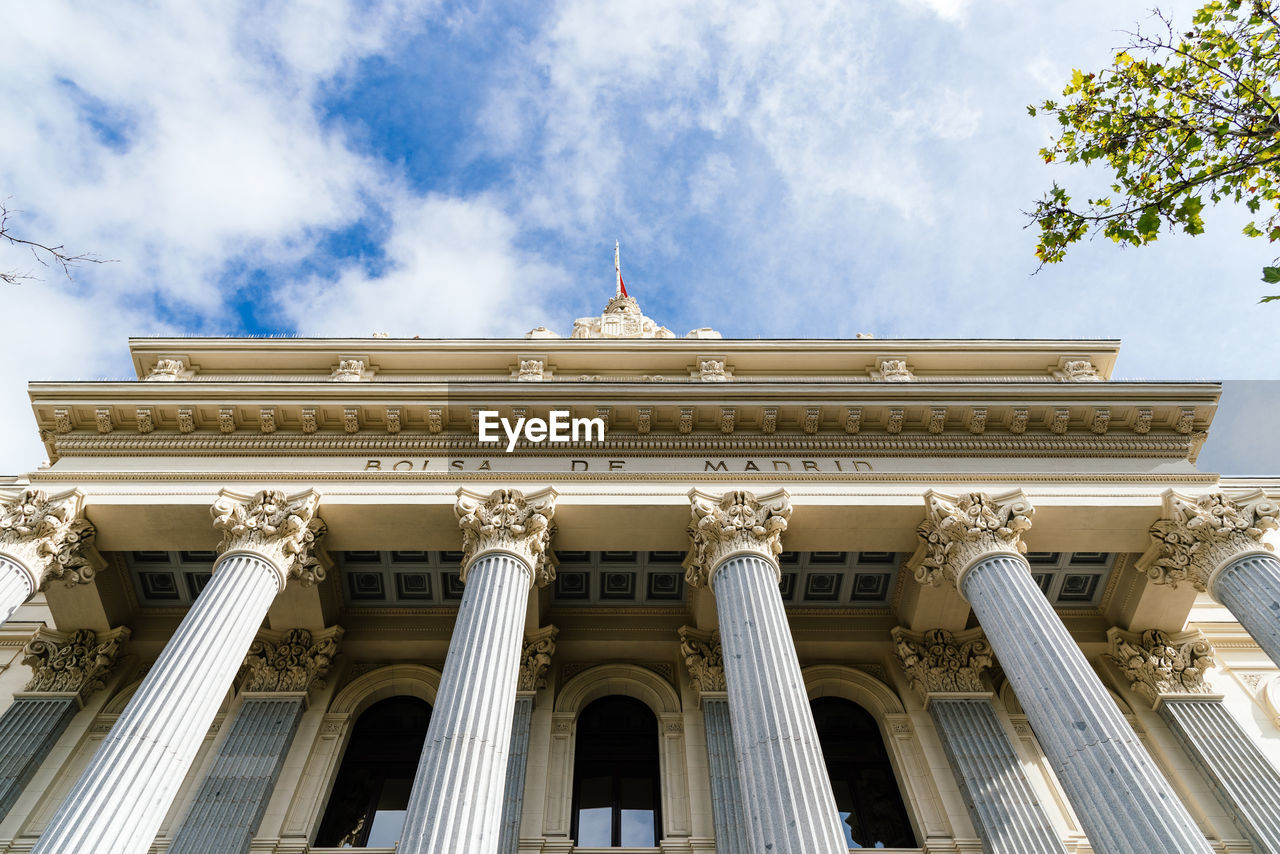 Low angle view of historical building against cloudy sky