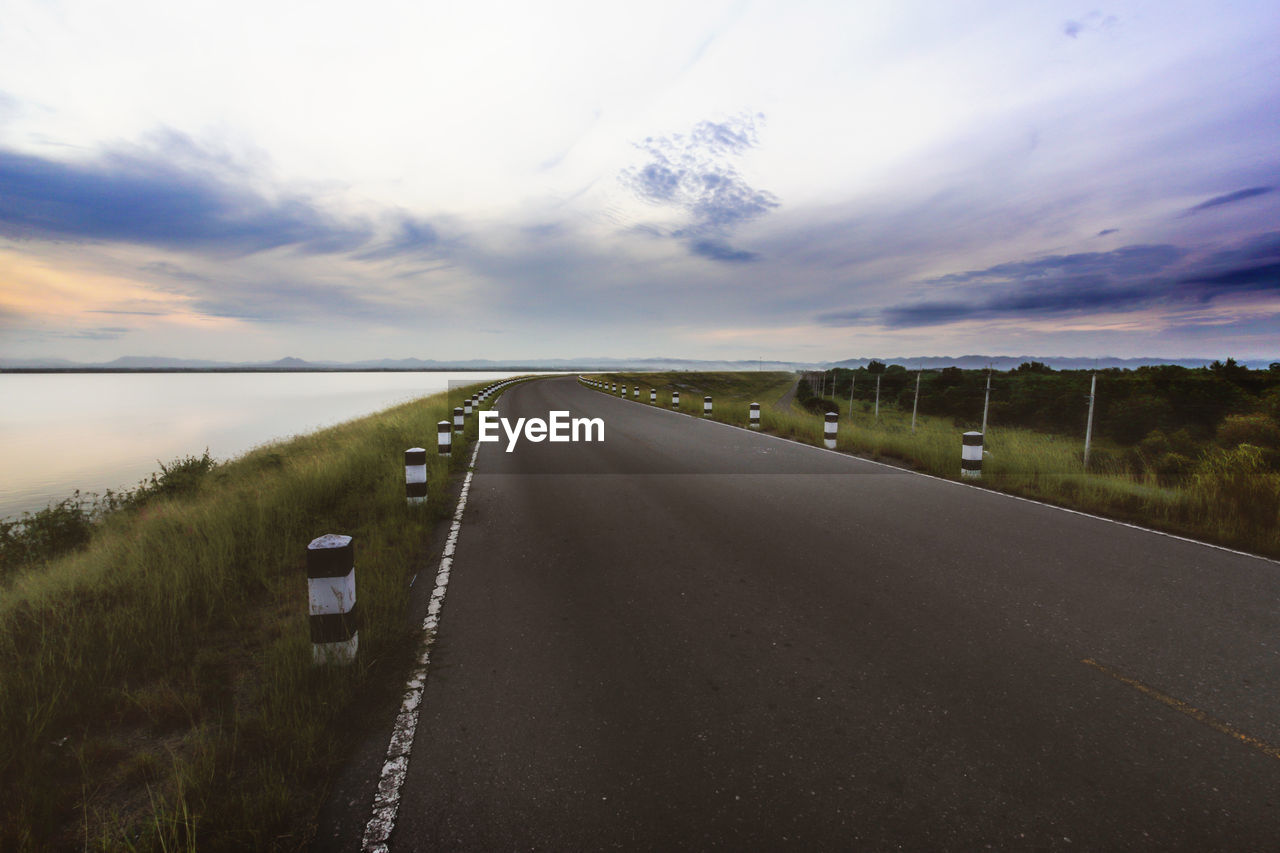 EMPTY ROAD AMIDST FIELD AGAINST SKY