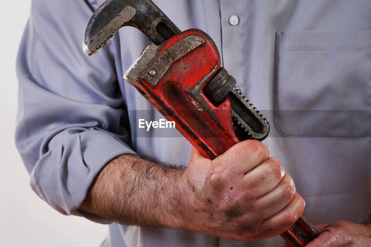 Midsection of man holding equipment