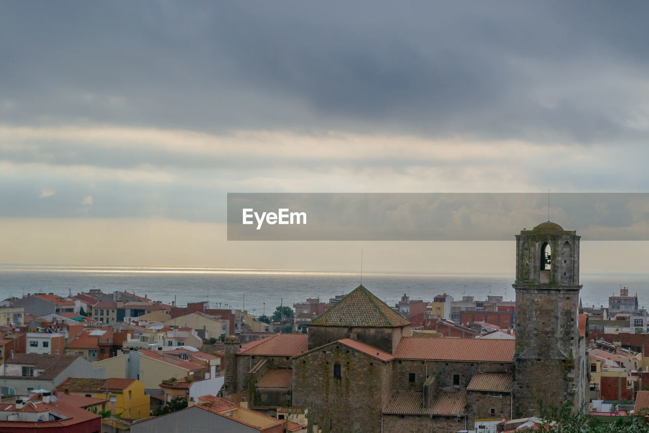 High angle view of townscape by sea against sky