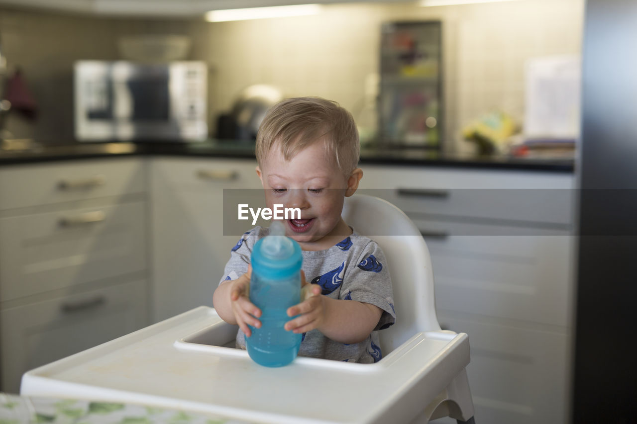 Smiling boy on high chair