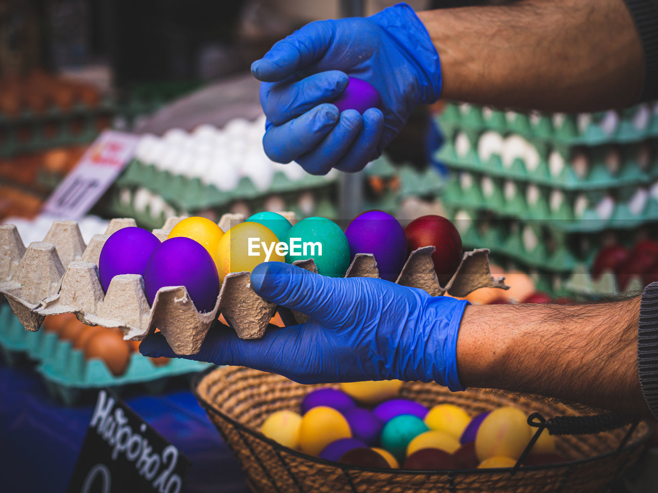 Cropped hand of woman holding multi colored decoration