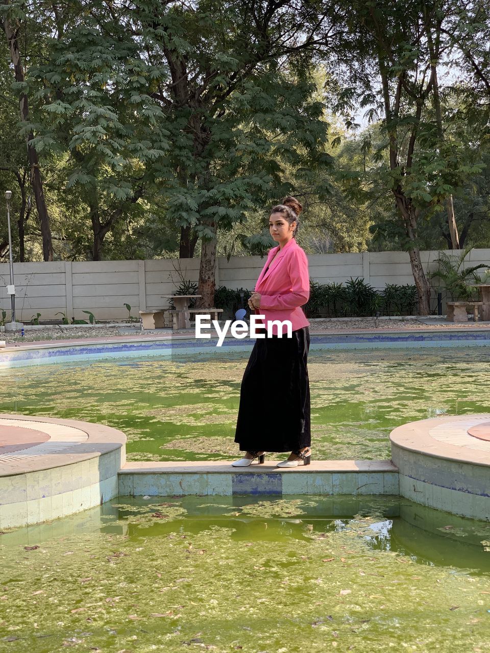 PORTRAIT OF MAN STANDING ON SWIMMING POOL