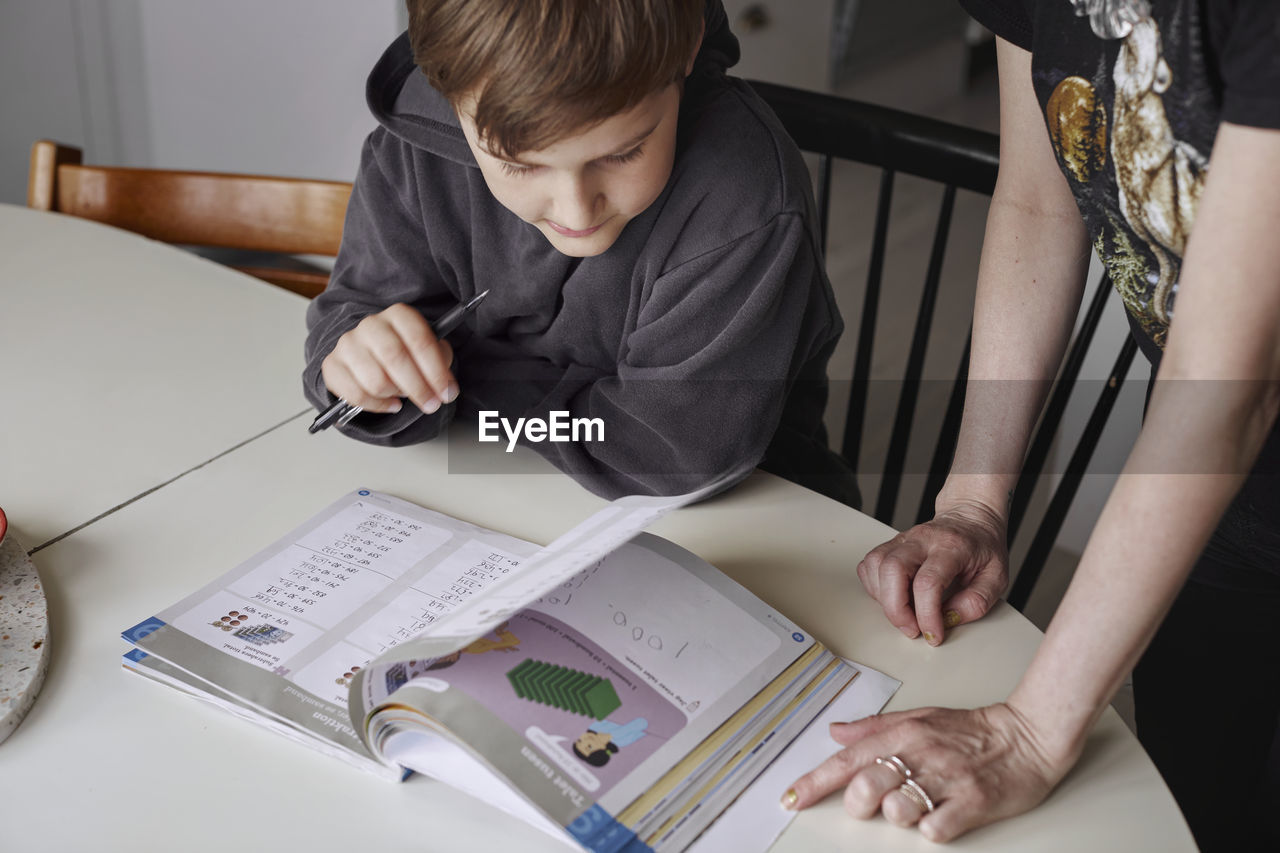 Mother helping son with homework